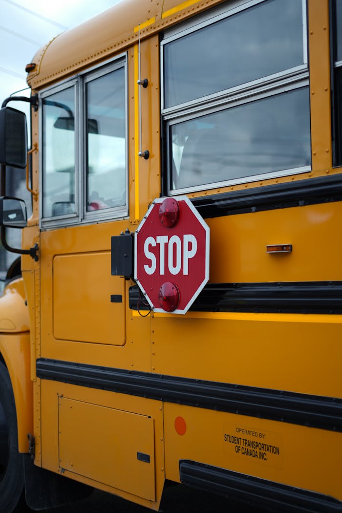 A yellow school bus in Kitchener, Ontario featuring a prominent stop sign.